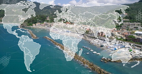 Displaying digital overlay mapping world map and hex grid over harbor, with boats and breakwaters