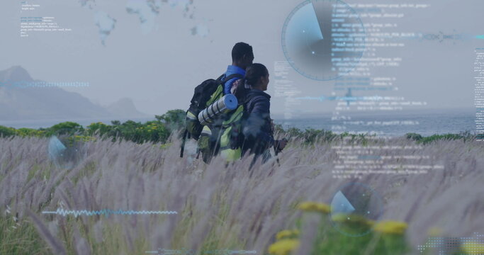 Hikers wearing gear and backpacks surveying coastal wildflower grassland, with code radar overlays - Powered by Adobe