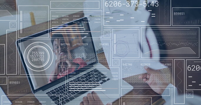 Laptop showing woman in red top speaking in office, with colleague typing and data overlays