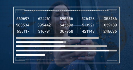 Holding smartphone and viewing digital data panel overlay against blue wall in denim jacket