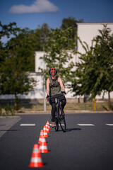 Teen Cyclist Navigating Road Cones on City Street