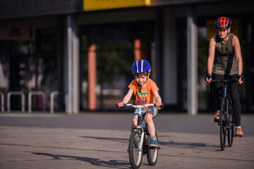 Child and Adult Biking Through Cones During Outdoor Practice