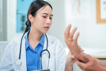 Female doctor examines patient using stethoscope in medical clinic. Professional nurse comforts...