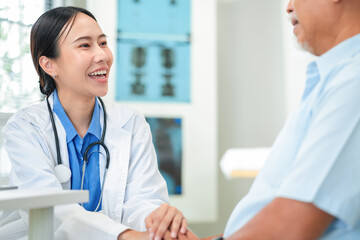 Female doctor examines patient using stethoscope in medical clinic. Professional nurse comforts...