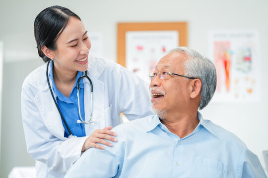 Asian healthcare professionals conduct medical consultations with senior patients using digital technology. Doctor examines elderly woman with stethoscope during comprehensive checkup