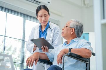 Asian healthcare professionals conduct medical consultations with senior patients using digital technology. Doctor examines elderly woman with stethoscope during comprehensive checkup