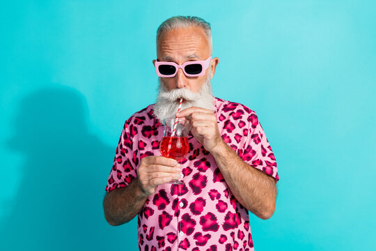 Photo of funny aged man sipping cocktail wear leopard print outfit isolated on teal color background