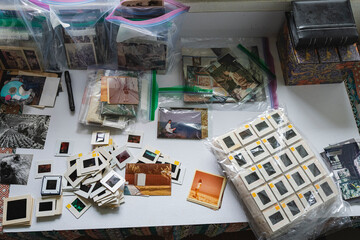 Top view of vintage photo slides and prints organized on a table