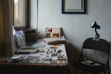 Vintage photo slides and prints on a desk in archival workspace