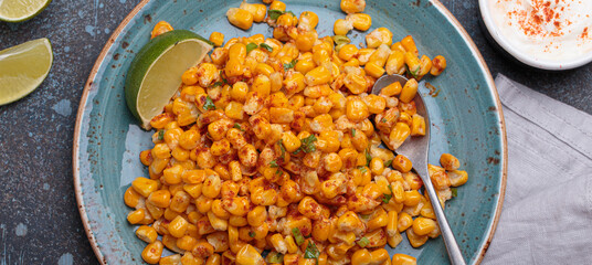 Esquites is a popular mexican street food dish made with grilled corn kernels, mayonnaise, cheese, chili powder, and lime juice, served on plate