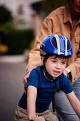 Smiling Boy Learning to Ride Bike with Encouragement