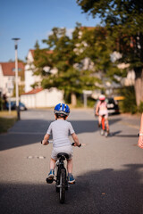 Child Riding Bicycle on Quiet Neighborhood Street