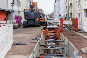 New modern insulated urban pipeline installation construction site  exposed underground pipes in...