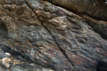 The surface of the gneiss cliffs of the mountains.  Texture and background of natural gneiss...