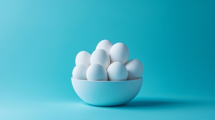 White eggs in blue bowl with bright pastel background for minimal food concept product photography scene