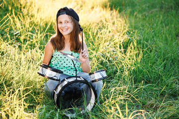 Portrait of smiling beautiful drummer girl crossed arms smiling at camera posing. Happy caucasian kid girl drummer. Girl playing on drum kit. Emotional portrait. Cheerful little girl playing drums.
