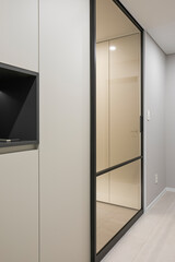 Install the front door with a black frame for a chic interior