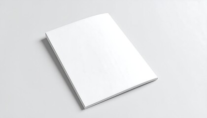 Fototapeta premium Blank white magazine/book lying flat on a light gray surface
