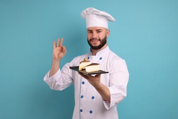 Happy confectioner in uniform holding pieces of delicious cheesecake and showing ok gesture on light blue background