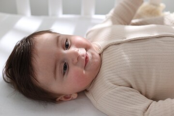 Bedtime. Cute little baby in crib at home