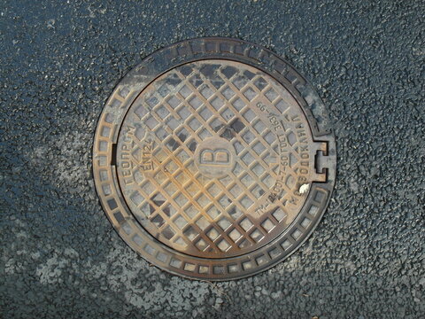 Rusty cast iron cover of the city's sewer water supply system.Cover for waste water pipe.