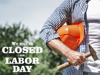 Signboard with the inscription We will be closed on Labor Day. Congratulations for family, loved...