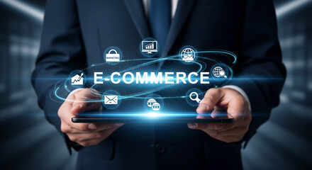 Businessperson holds tablet showcasing e-commerce concept, symbolized by digital icons and glowing text, representing online business and technology