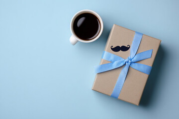 Black espresso mug with hot coffee and a gift box on a white table for morning breakfast