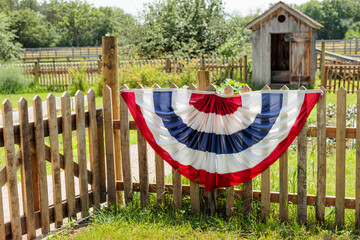 July 4th bunting along the fence of the gardens at Old World Wisconsin near Eagle, Wisconsin