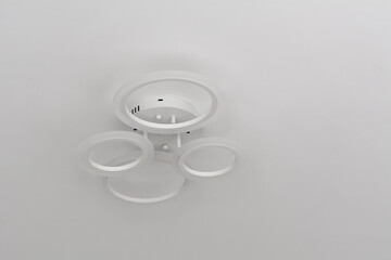 Modern LED chandelier formed from four flat circles. Selective focus. Shallow depth of field.