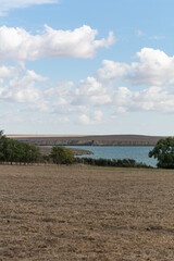 Lake Tashaul. Lake landscape. Dry field in the foreground. Selective focus, shallow depth of field.