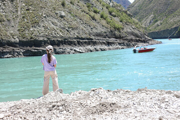 The Sulak Canyon in Dagestan. Beautiful mountain nature. The mood to travel. New impressions. The Blue River. An incredible landscape. A girl admiring the beautiful panorama. Boat trips on the river