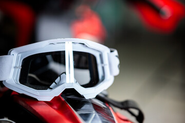 A pair of goggles sits on a red surface