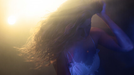 Mystical close-up of woman with windblown hair, cinematic colored lights creating dreamlike...