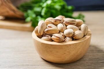 Dry Roasted and Salted Pistachios in wooden bowl