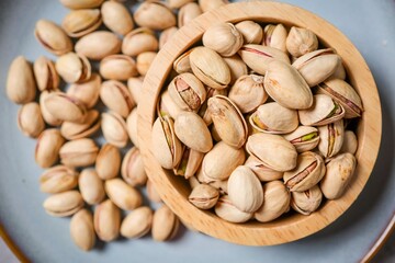 Dry Roasted and Salted Pistachios in wooden bowl
