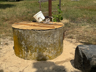 A mine well with concrete rings. Topped with white sand for protection and filtration.