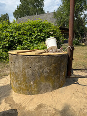 A mine well with concrete rings. Topped with white sand for protection and filtration.