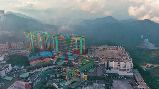 Genting Highlands, Malaysia: Aerial drone view of famous Genting Highlands in clouds at sunset - landscape panorama of Southeast Asia from above
