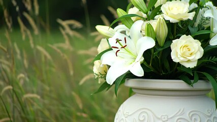 Elegant White Lilies and Roses in a Decorative Vase
