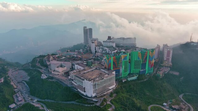 Genting Highlands, Malaysia: Aerial drone view of famous Genting Highlands in clouds at sunset - landscape panorama of Southeast Asia from above
