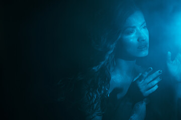 To touch the mystery, the concept. Portrait of a beautiful woman looking with interest at the...