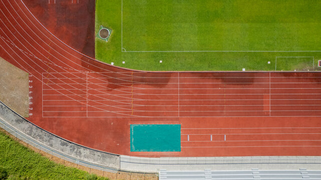 Aerial view of the Manuela Machado Municipal Stadium in Viana do Castelo, Portugal. Eight empty red tracks for running sports with tartan track of synthetic rubber on the athletic stadium.