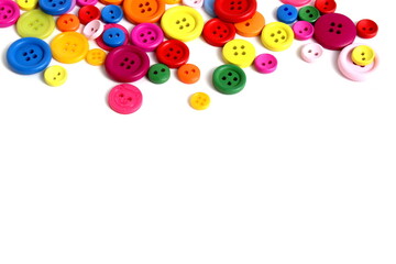 There are many multi-colored buttons on a white background.