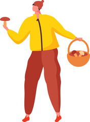 Young mushroomer walking through the woods in a yellow jacket and red trousers, holding a large freshly harvested mushroom in a wicker basket
