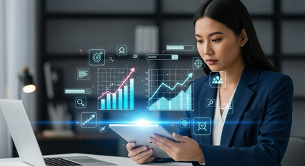 Businesswoman analyzing financial data on a tablet with holographic charts