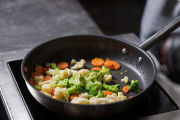 Vegetables frying in pan during cooking