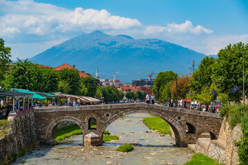 Fototapeta premium Old Stone Bridge over Lumbardhi River at the Old Town of Prizren in Kosovo