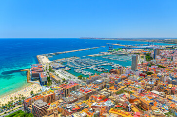 Aerial panoramic view of old town Alicante, panorama of Alicante city historical centre, centro Alacant, Port of Alicante seaport harbor with yachts in Alicante bay of Mediterranean Sea, Spain