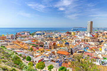 Aerial panoramic view of old town Alicante with buildings, panorama of Alicante city historical centre, Port of Alicante seaport in Alicante bay of Mediterranean Sea, Valencian Community, Spain
